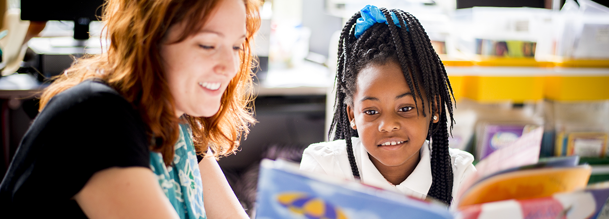 A student teacher reads to an elementary school student in Richmond Public Schools.