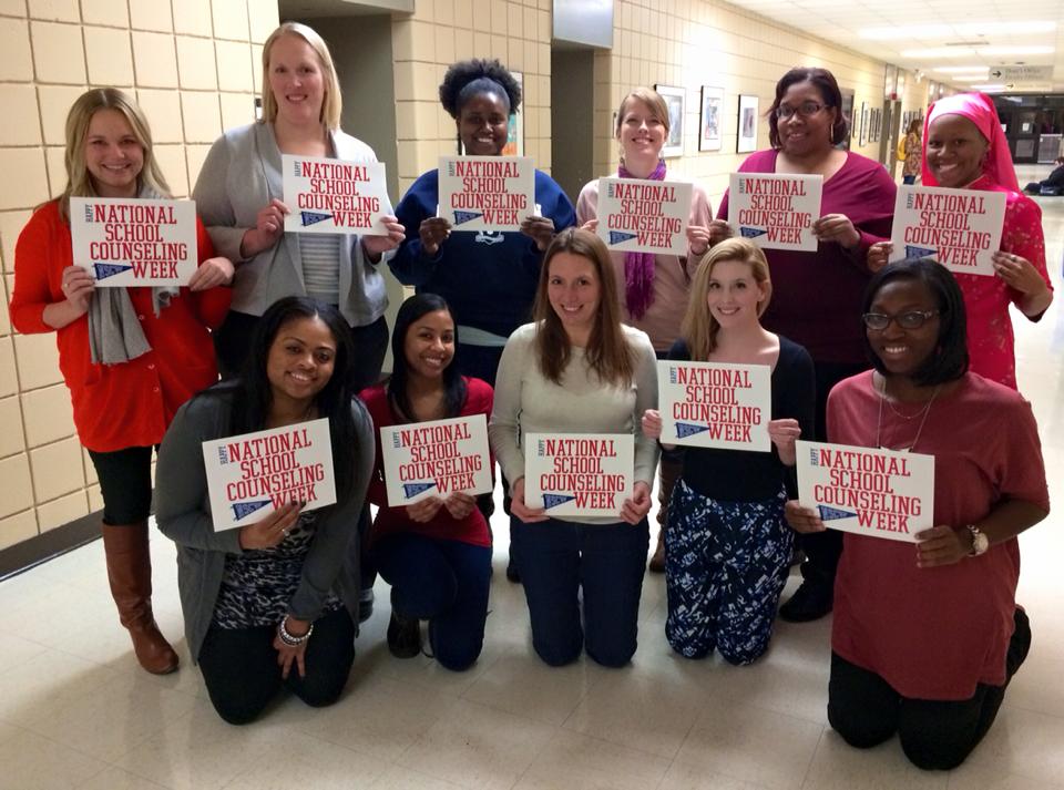 A group of students holding signs celebrating National School Counseling Week.