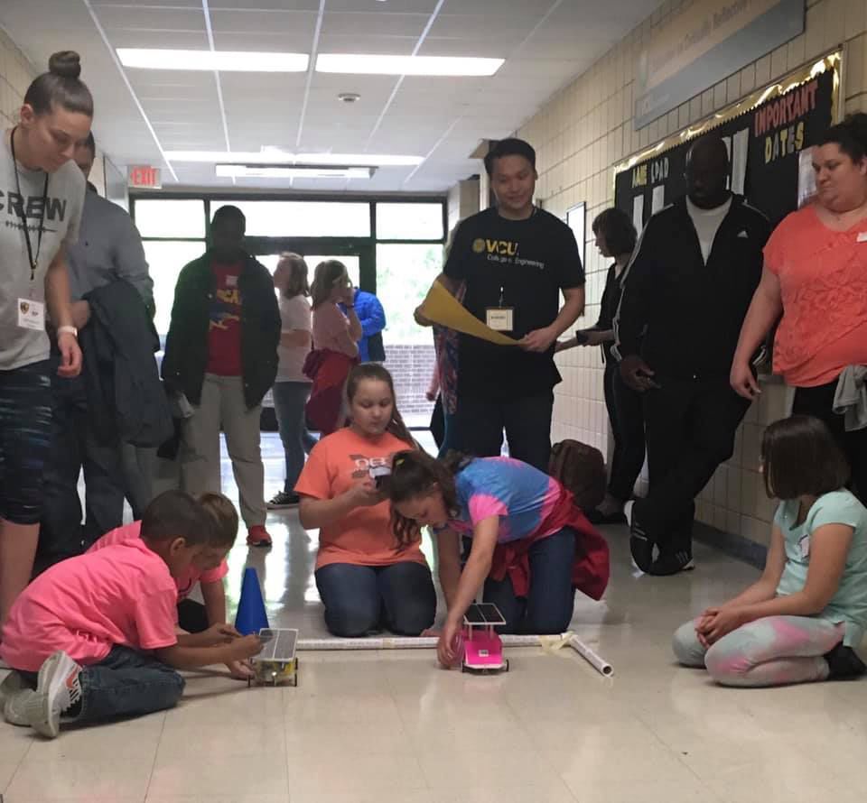 Dixie Randolph (in blue) and her teammates prepare to race the solar car they designed and built. Teams from Bowling Green and Madison elementary schools in Caroline won first place overall at a solar car competition hosted last month by VCU. (CCPS)