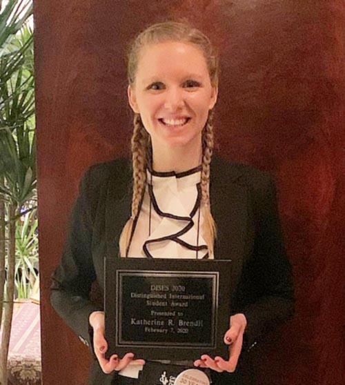 Katie Brendli holds the Division of International Special Education & Services (DISES) Distinguished Student Leadership/Service Award, presented to her on February 7, 2020.