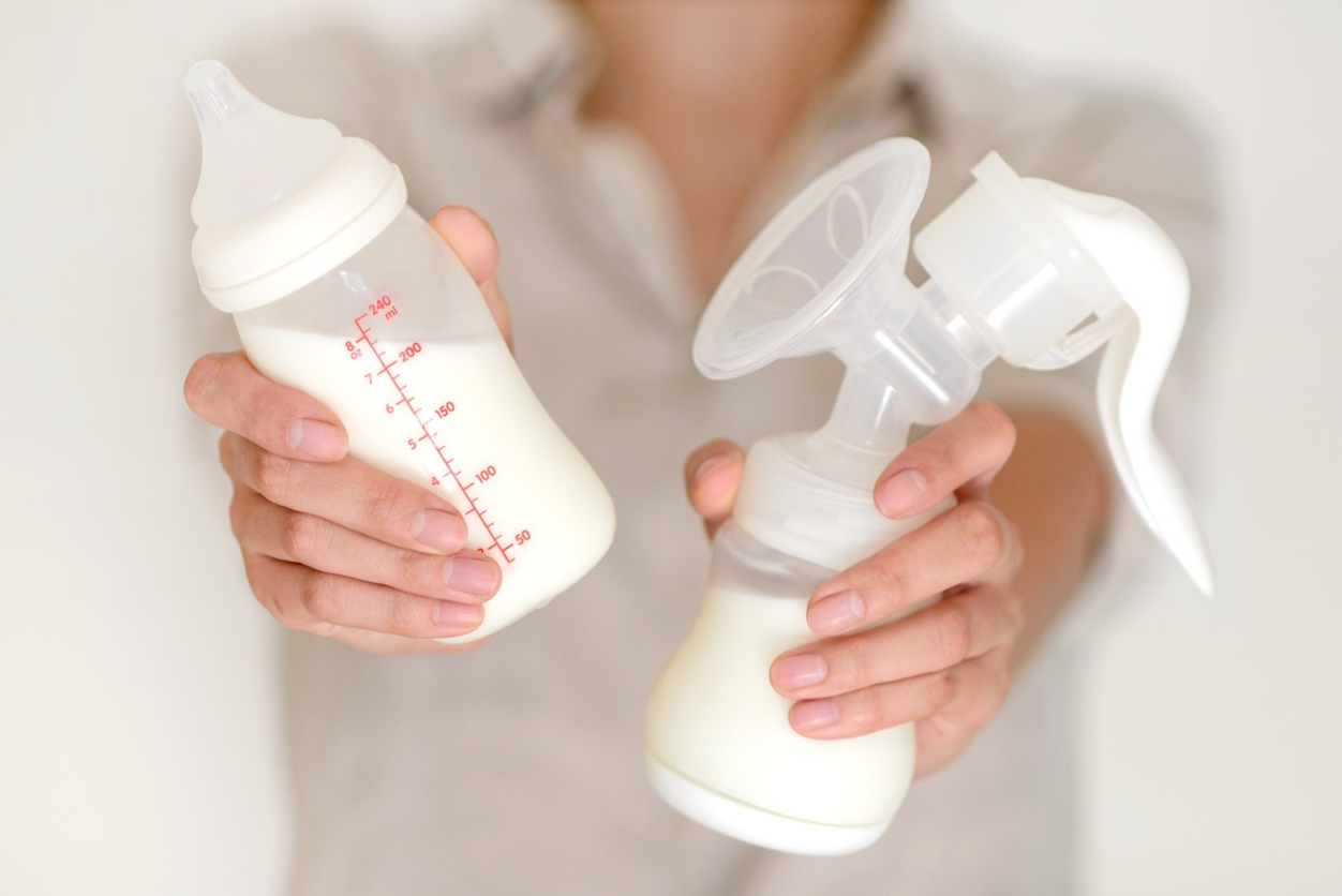 Getty Image of a baby bottle and a breast pump.