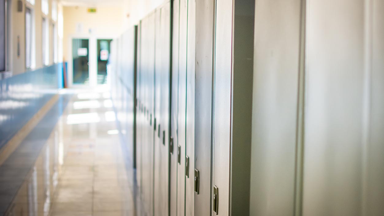 An empty hallway with lockers in a high school setting. (Getty Image)