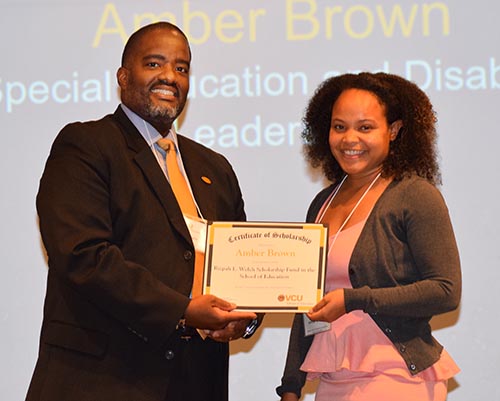 Dean Andrew Daire presents the Rizpah L. Welch Scholarship to Amber Brown at the 2019 Scholarship and Awards Ceremony in October 2019.