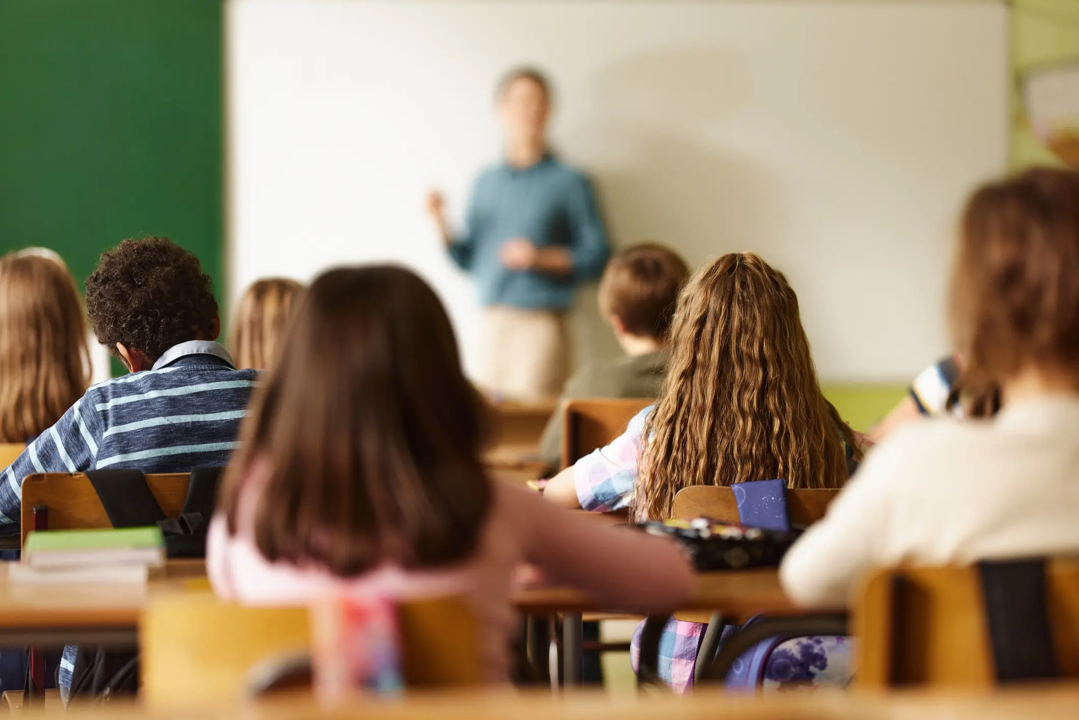 middle school students in a classroom with teacher at the front